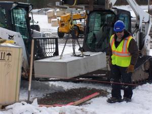 Construction workers outside working in the snow